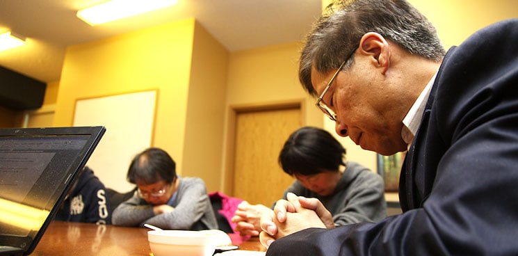 Eldery Korean men and women praying